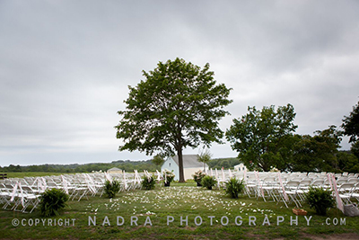 Wedding chairs overlook fields. Photo &copy; Nadra Photography.